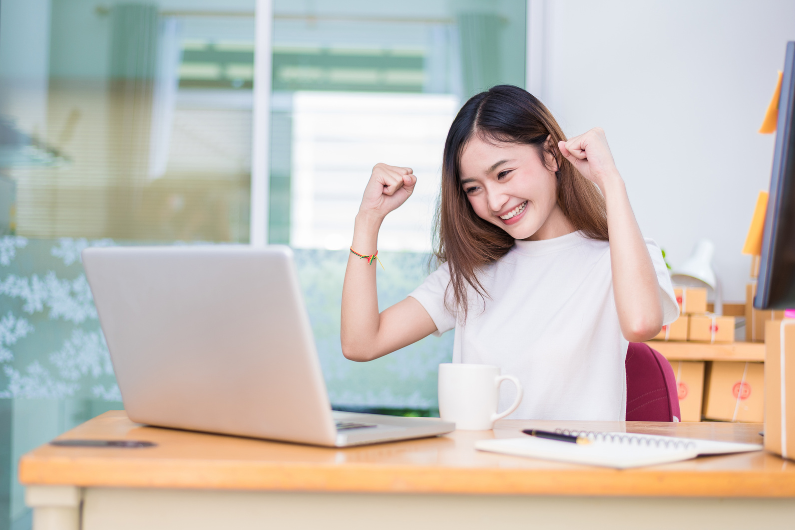 Woman is Excited While Looking at Laptop